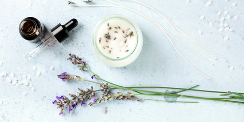 Handmade lavender scented candle with essential oil, flowers, wax and wicks, panoramic flat lay...