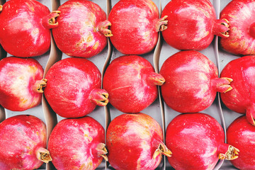 pomegranates are on the counter in a vegetable store
