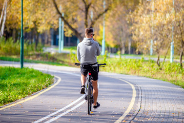 Fototapeta premium Cyclist ride on the bike path in the city Park