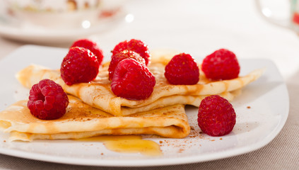 delicious  pancakes with fresh raspberries and honey