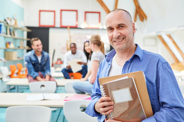 Smiling man as a lecturer with documents