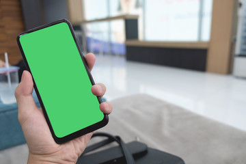 Cropped hand of man using mobile phone, mock up on screen