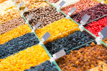 Pile of raisins, different kinds of nuts and other organic food on shop counter