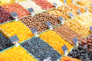 Pile of raisins, different kinds of nuts and other organic food on shop counter