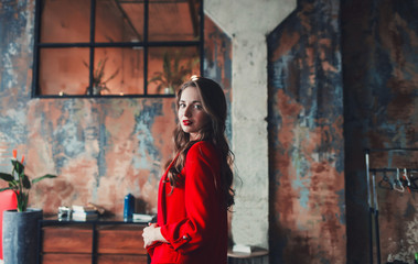 charming business lady in red suit in loft interior