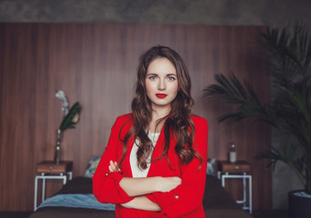 portrait of a beautiful successful lady in a red suit