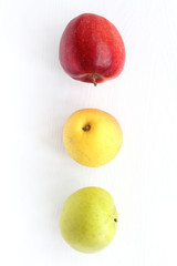 red, yellow and green apples on the table top view. fruit traffic light