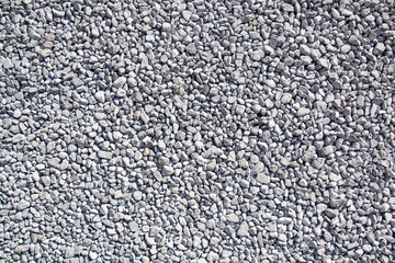 Ground granite stones as gray background.