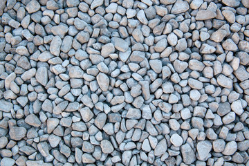 Ground granite stones as gray background.