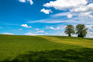 The sky and landscape in Bavaria, closed to the mountains the alps with beatufil clouds, fields and lakes  