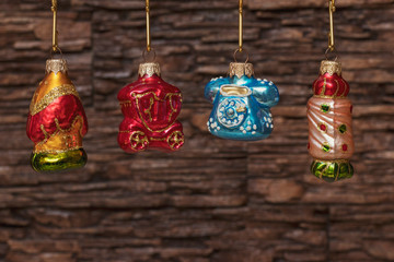 Christmas tree glass toys in retro style hang in a row on golden hooks. Great background for a Christmas card and greetings.