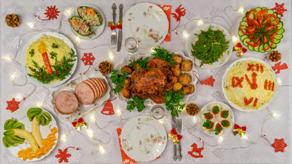 Festive Christmas served table with delicious food and decorative items. Dinner for New Year party, Christmas turkey. Winter holiday celebration at cozy home. Top view