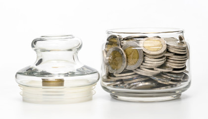 coins in glass bottle on white background,business saving and investment concept