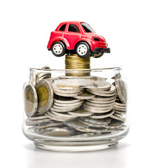 coins in glass bottle and car on white background,business saving and investment concept