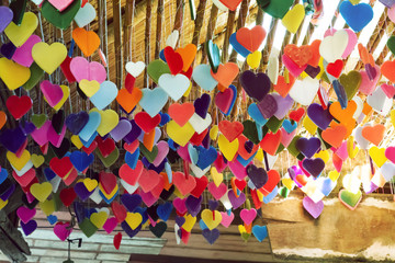 Multicolored hearts-shaped made of candle hanging from bamboo ceiling,valentine day and love concept.