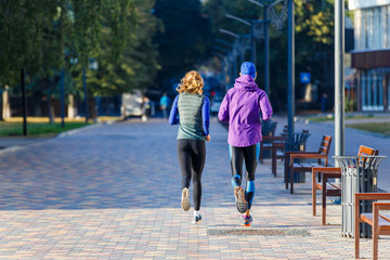 Young couple jogging in city in the morning