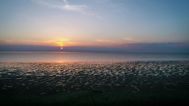 Right Moving Shot of Beautiful Sunset with Birds and Purple Clouds at the Wadden Sea, The Netherlands, 4K Drone Footage