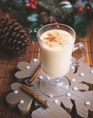 Traditional egg cocktail with cinnamon stick.