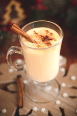 Traditional egg cocktail with cinnamon stick.