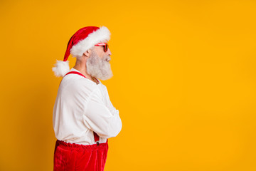 Profile side photo of serious brutal santa claus hipster look funky copyspace cross hands want celebrate christmas fairy newyear time fast isolated yellow color background