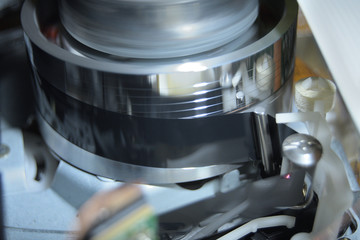 Cassette tape in Vhs video mechanism helical head reading a videotape