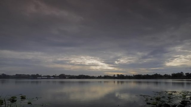 Time lapse of dark clouds moving above the lake with rain storm in the sky background, Krajub reservoir, Nonk Kop in Ban Pong District, Ratchaburi, Thailand.