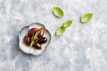 Kalamata olives on bright wooden background. Top view. Copy space.