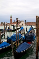 gondolas parked in venice st. George church view