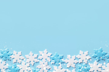 Christmas New Years background white blue snow flakes on cyan backdrop. Minimalist elegant style for holiday poster banner with copy space