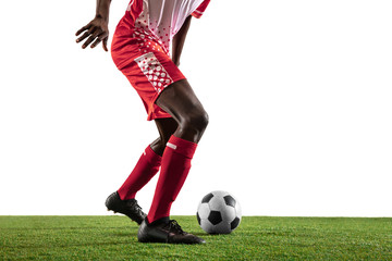 Obraz premium Professional african-american football or soccer player of red team in motion isolated on white studio background. Fit man in action, excitement, emotional moment. Concept of movement at gameplay.