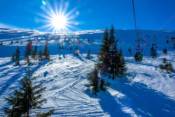 Bright Sun over an Unequipped Ski Slope and Chair Lift