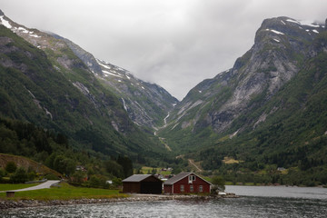 Fototapeta na wymiar Remote house in Norwegian fjord. Amazing landscape in Norway.