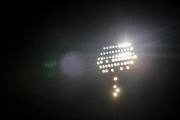 spotlights in the stadium by dark with rain