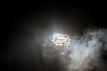 spotlights in the stadium by dark with rain