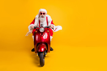 Full length photo of crazy funky santa claus in red hat drive motorcycle ride fast hurry to x-mas...