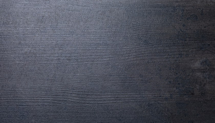 Imitation of wood texture on the surface of the flooring in dark color close-up.