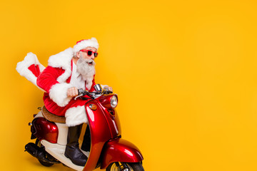 Profile side photo of shocked crazy santa claus ride fast his scooter hurry on x-mas party wear shirt suspenders drive copyspace isolated over yellow color background