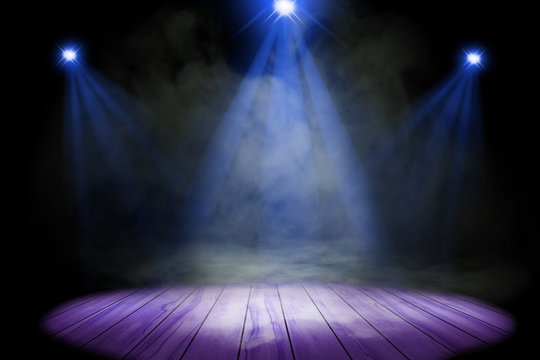 Blue purple lighting and smoke on stage with floor wood
