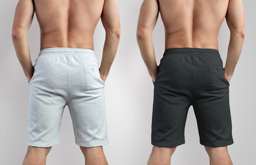 Design mockup white and black shorts  on a man, isolated on background, back view
