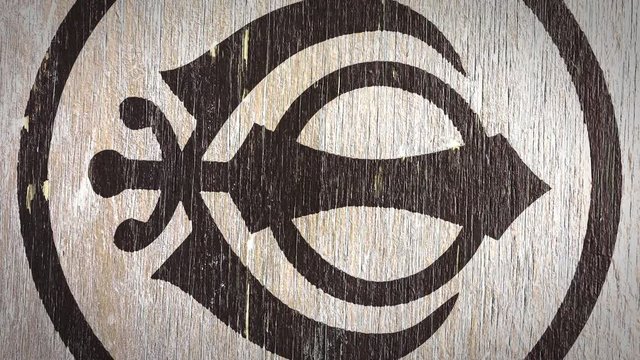 Khanda - Sikh Symbol On Wodden Texture. Ideal For Your Sikh / Religion Related Projects. High Quality Seamless Animation. 4K, 60fps