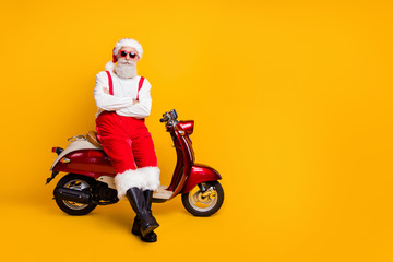 Full body photo of self-confident santa man festive mood ready x-mas theme party sitting retro bike...
