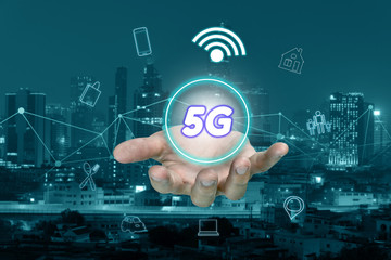 5G network interface on hand and icon concept with cityscape blurred background