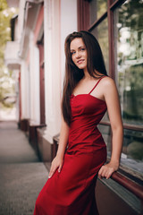 Fototapeta premium Portrait of beautiful brunette woman with makeup in fashion red clothes