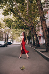 Fototapeta na wymiar Portrait of beautiful brunette woman with makeup in fashion red clothes