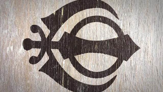 Khanda - Sikh Symbol On Wodden Texture. Ideal For Your Sikh / Religion Related Projects. High Quality Seamless Animation. 4K, 60fps