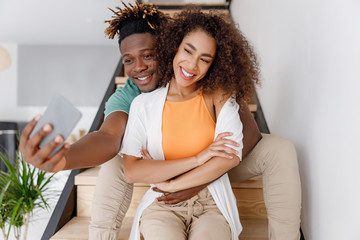 Joyful man making selfie with his girlfriend