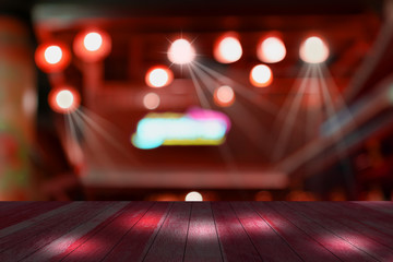 top red desk with blur restaurant background,Wooden table and blurred bokeh of night street...