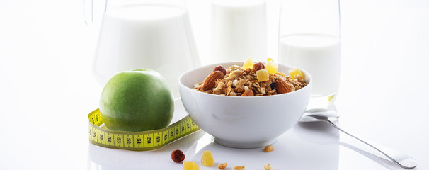 Health food. Muesli with milk and the baked apple. High key. Close up. Selective focus.