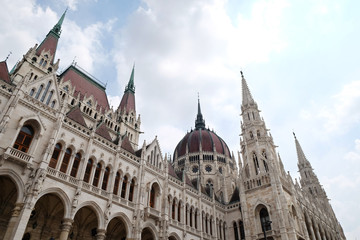 View of historical building of Hungarian Parliament in Budapest, Hungary, Europe on background of bright blue cloudy sky
