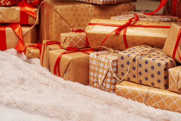 Fototapeta na wymiar Stack of christmas gifts on beige carpet